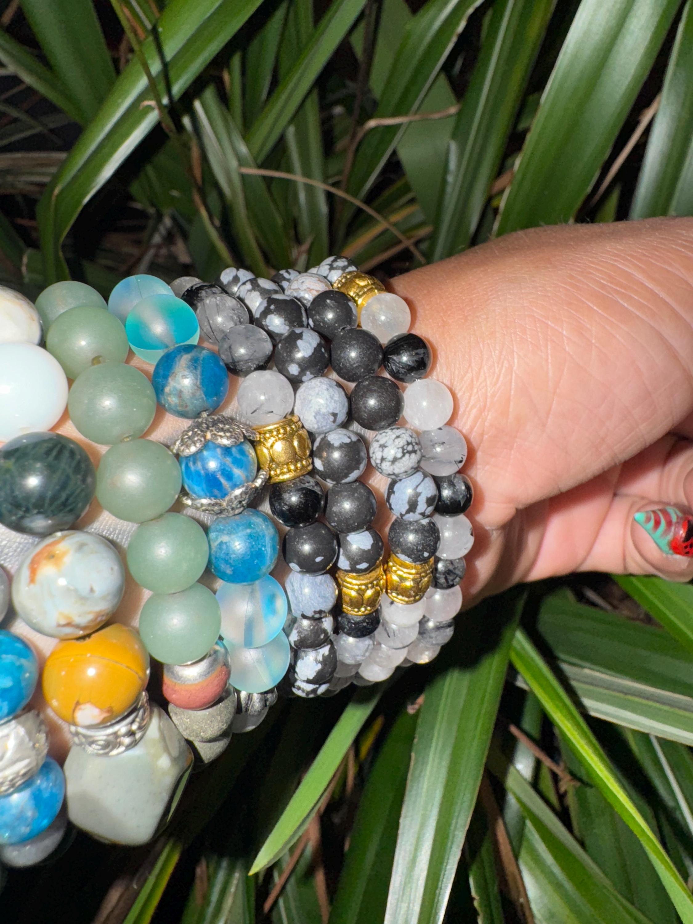 Rutiled quartz and snowflake obsidian . Medium (6mm beads)