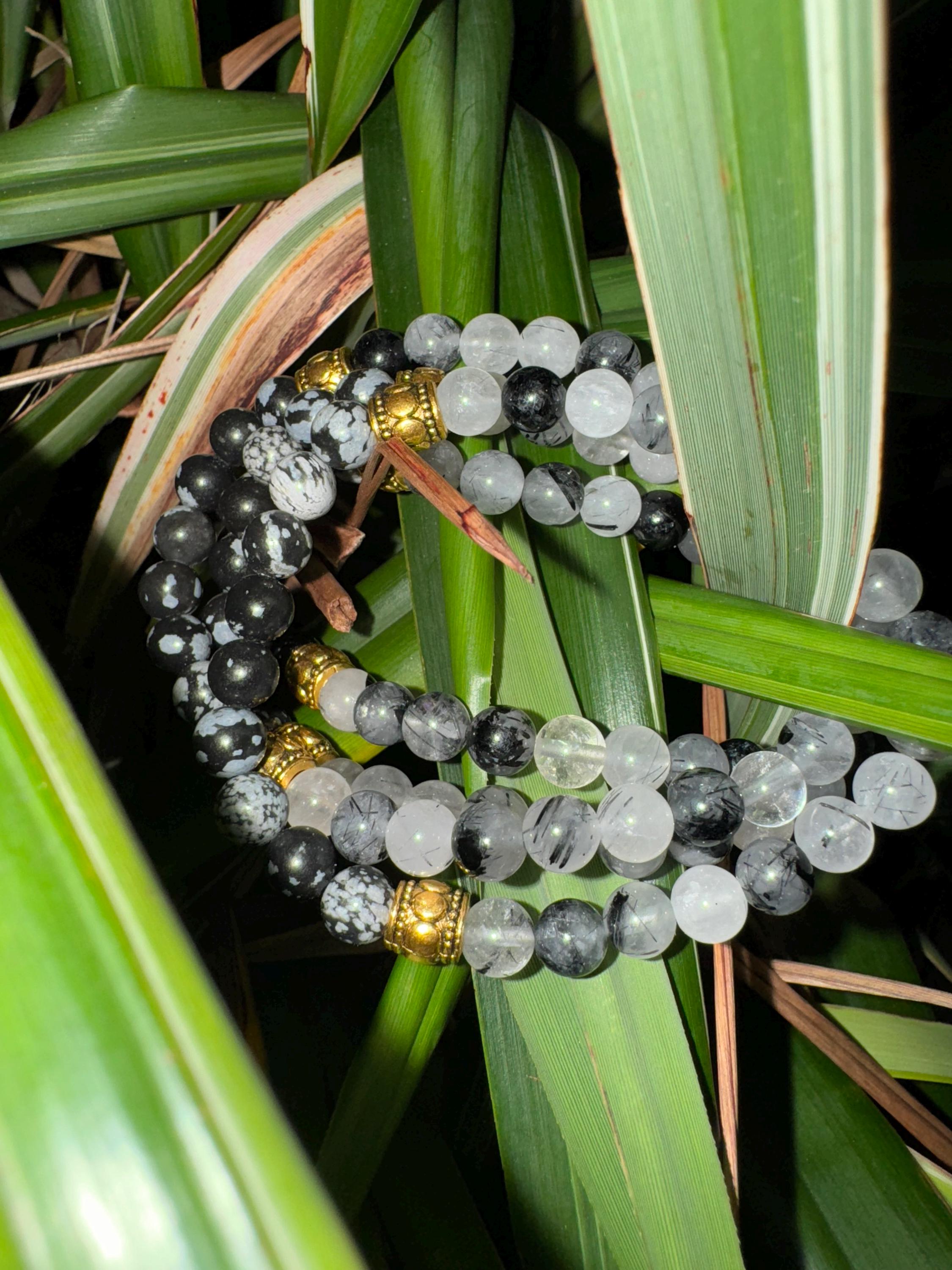 Rutiled quartz and snowflake obsidian . Medium (6mm beads)