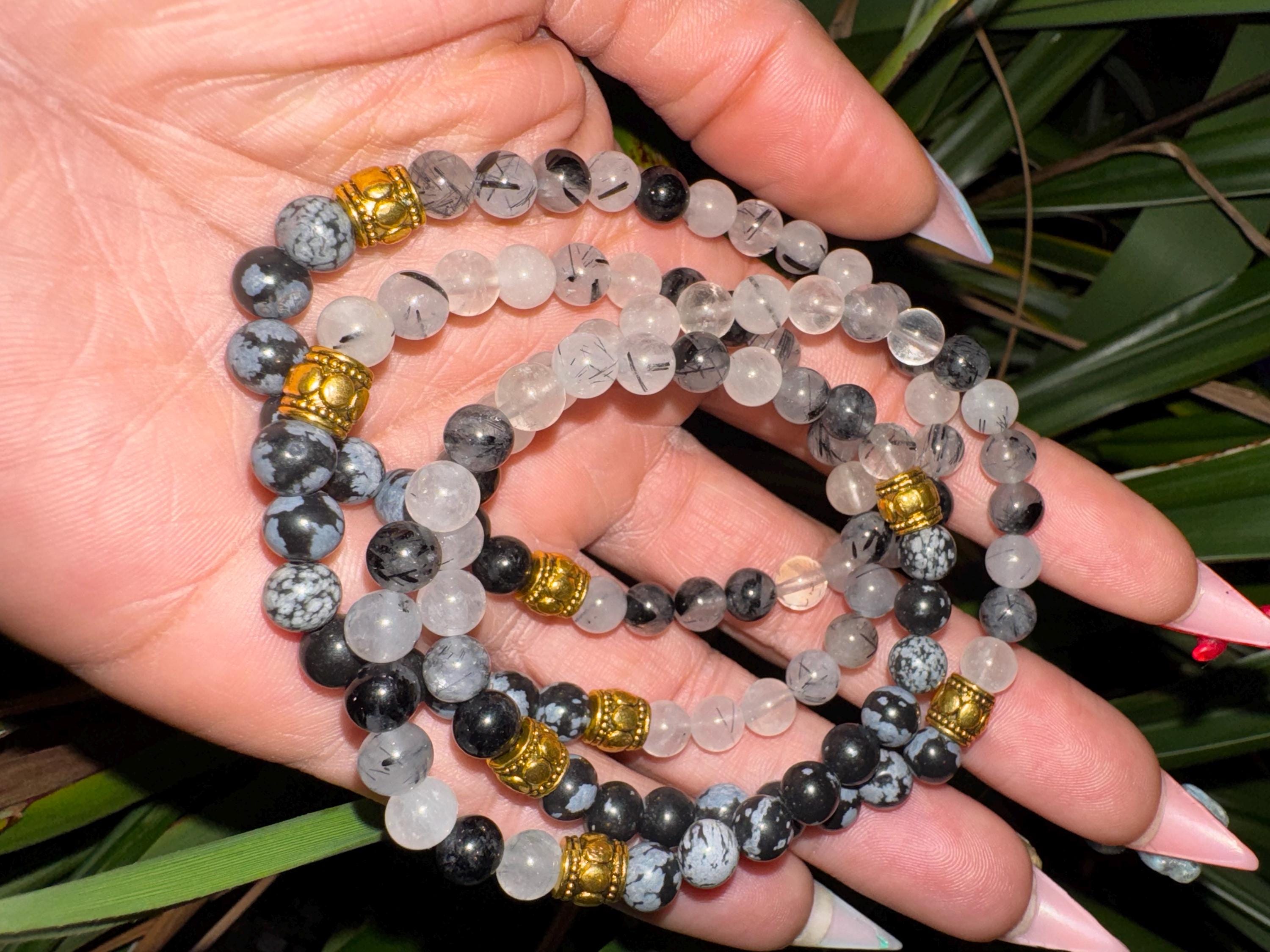 Rutiled quartz and snowflake obsidian . Medium (6mm beads)