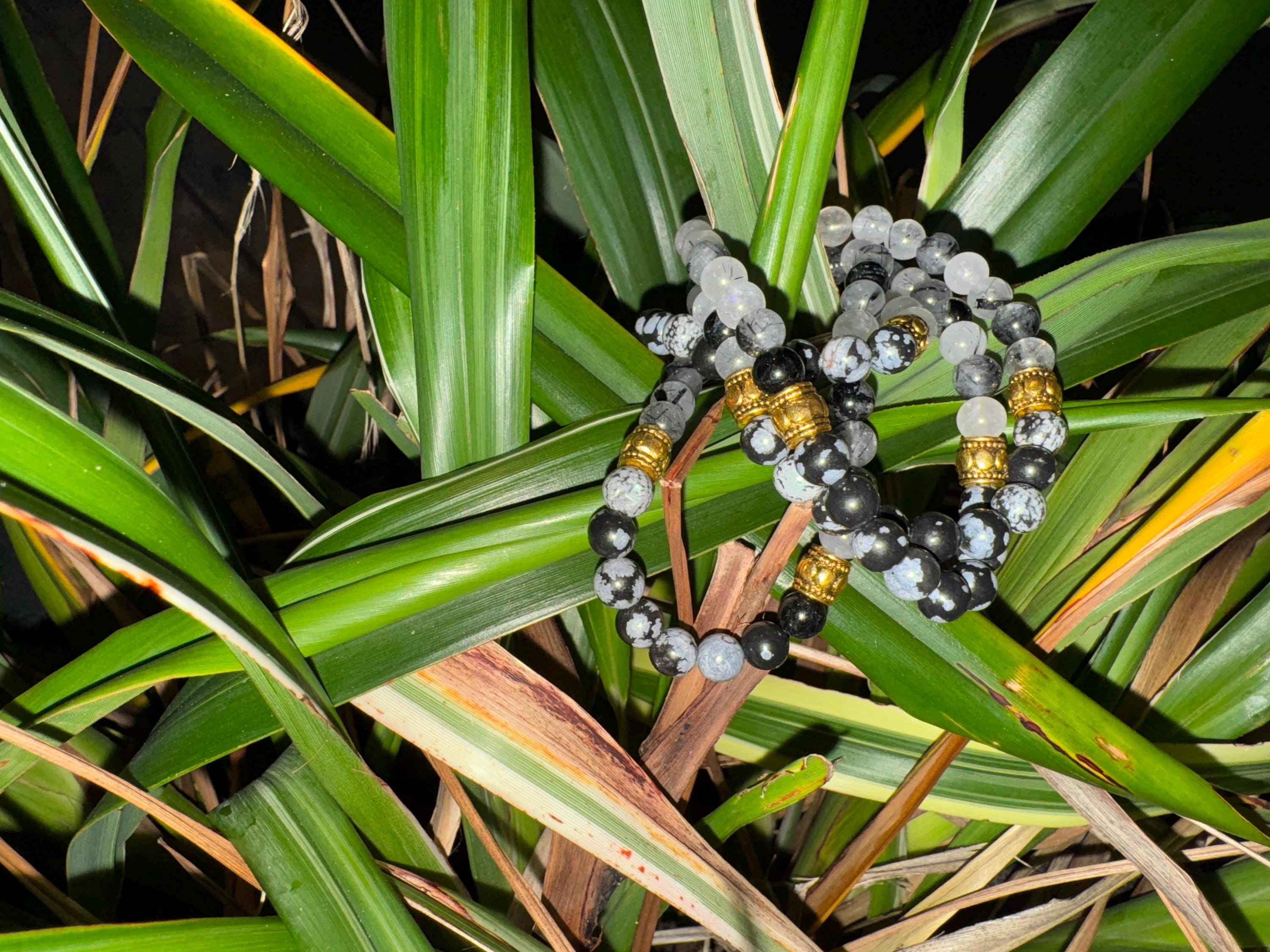 Rutiled quartz and snowflake obsidian . Medium (6mm beads)